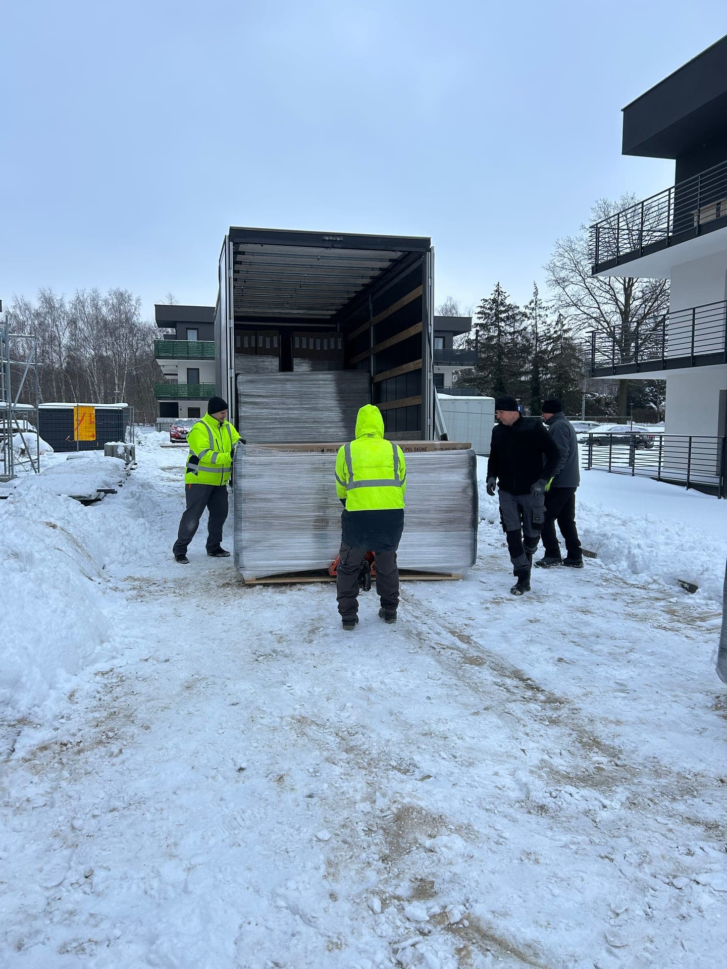 Team unloading door packages from a delivery truck