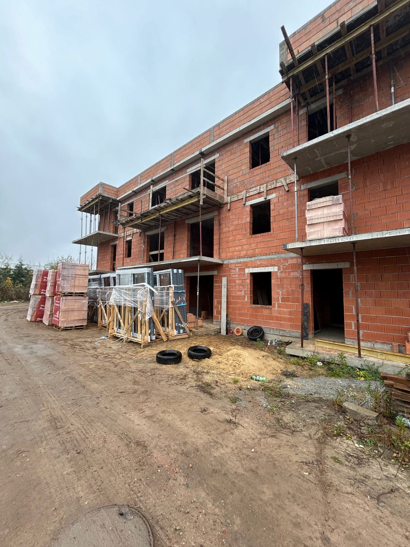 Residential apartment building shell with window crates staged on site