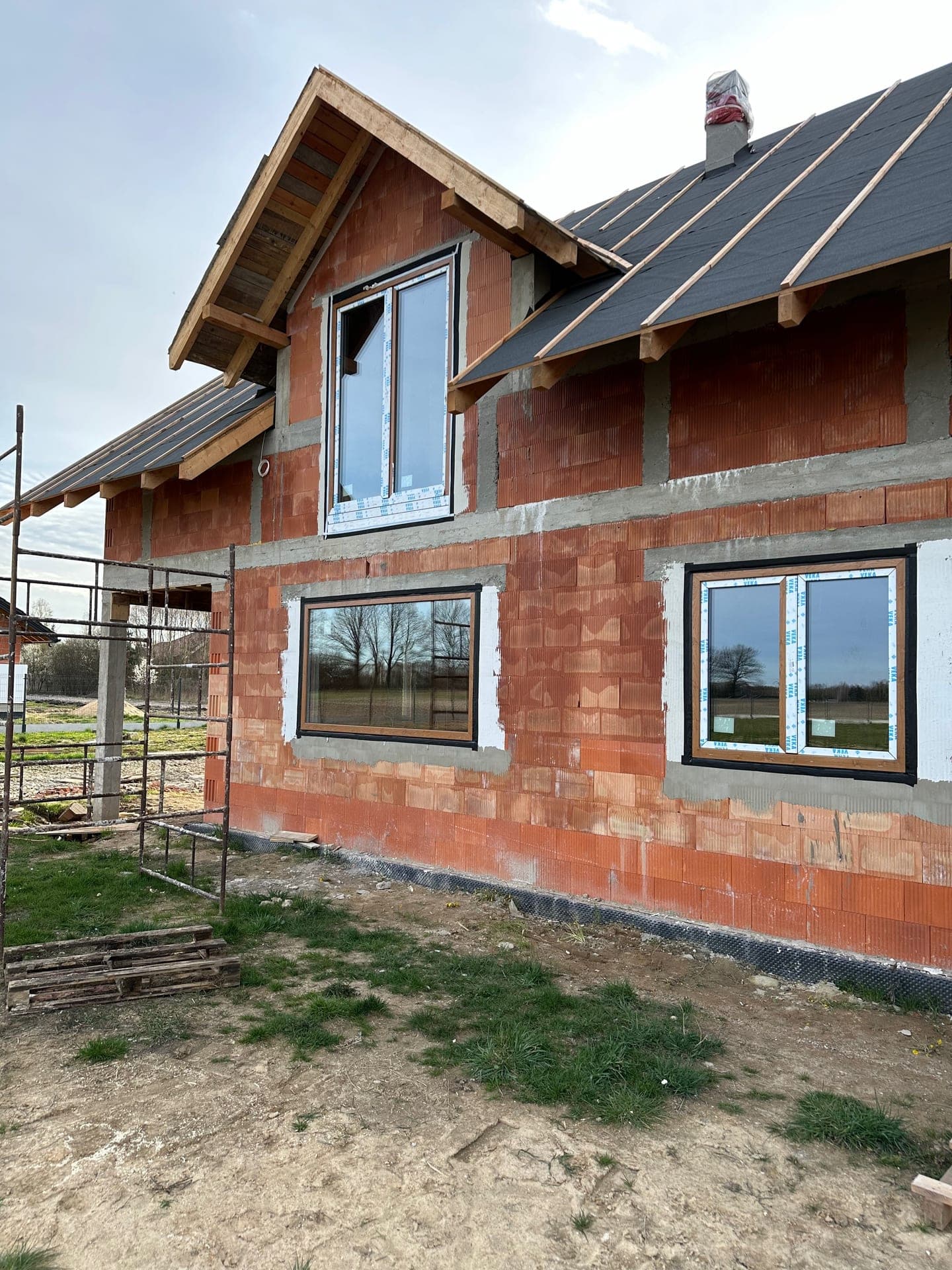 Dark-frame PVC windows installed in a detached house under construction